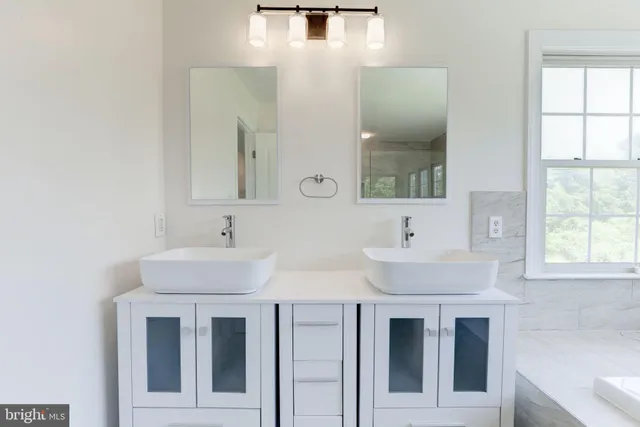 a bathroom with a sink a mirror and shower