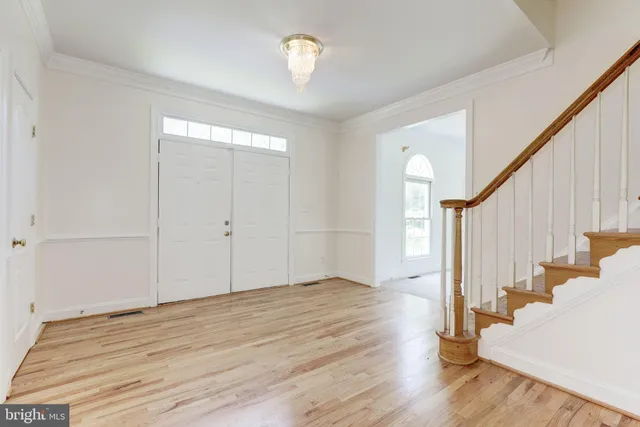 an empty room with windows and mirror