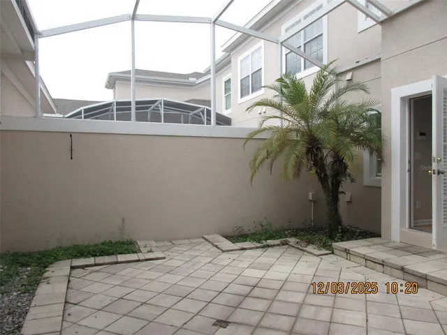 a backyard of a house with potted plants
