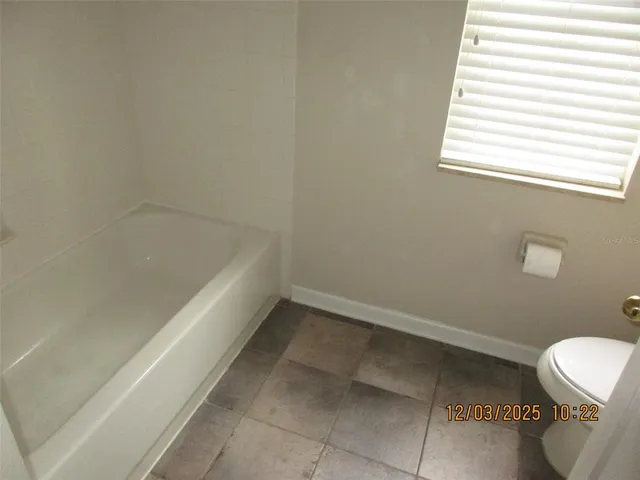 a bathroom with a bathtub and window