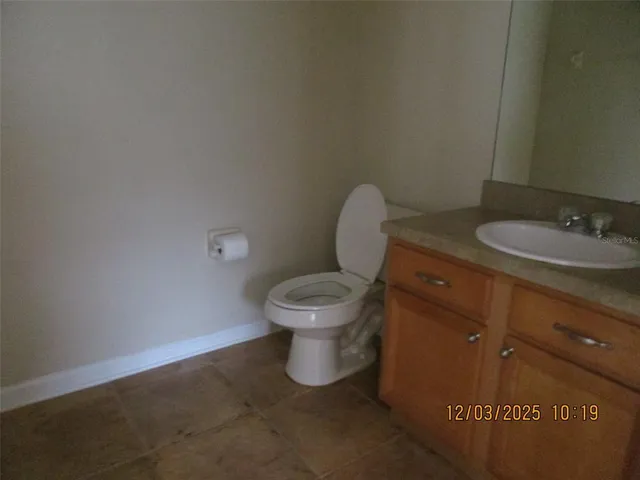 a white toilet sitting next to a bathroom sink