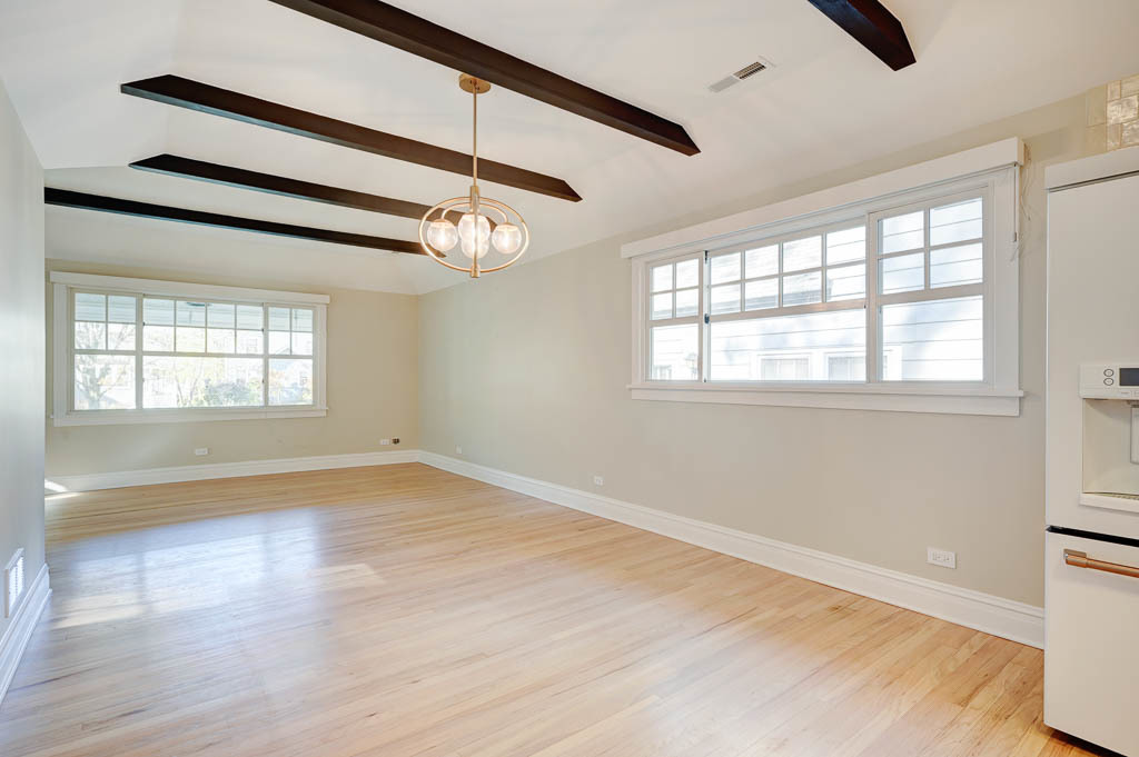 2211 Pioneer Road Evanston, IL 60201 - Photo 6 of 20 an empty room with wooden floor fan and windows