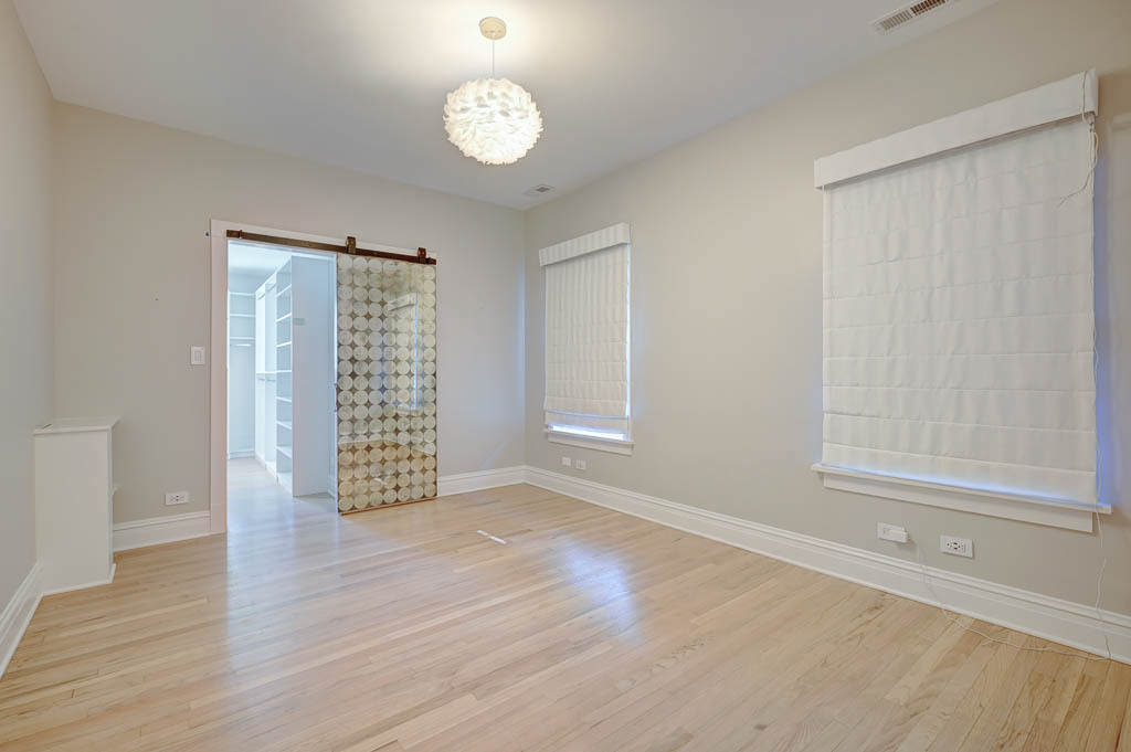 2211 Pioneer Road Evanston, IL 60201 - Photo 9 of 20 an empty room with wooden floor and windows