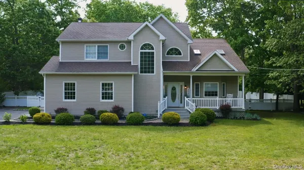a front view of a house with a garden and yard