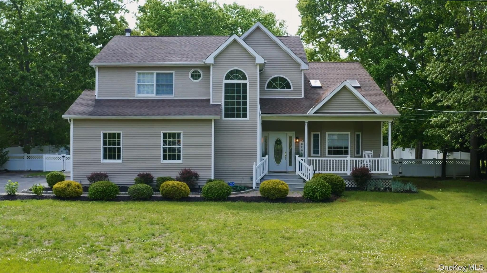 5 Mill Race Road Hampton Bays, NY 11946 - Photo 1 of 34 a front view of a house with a garden and yard