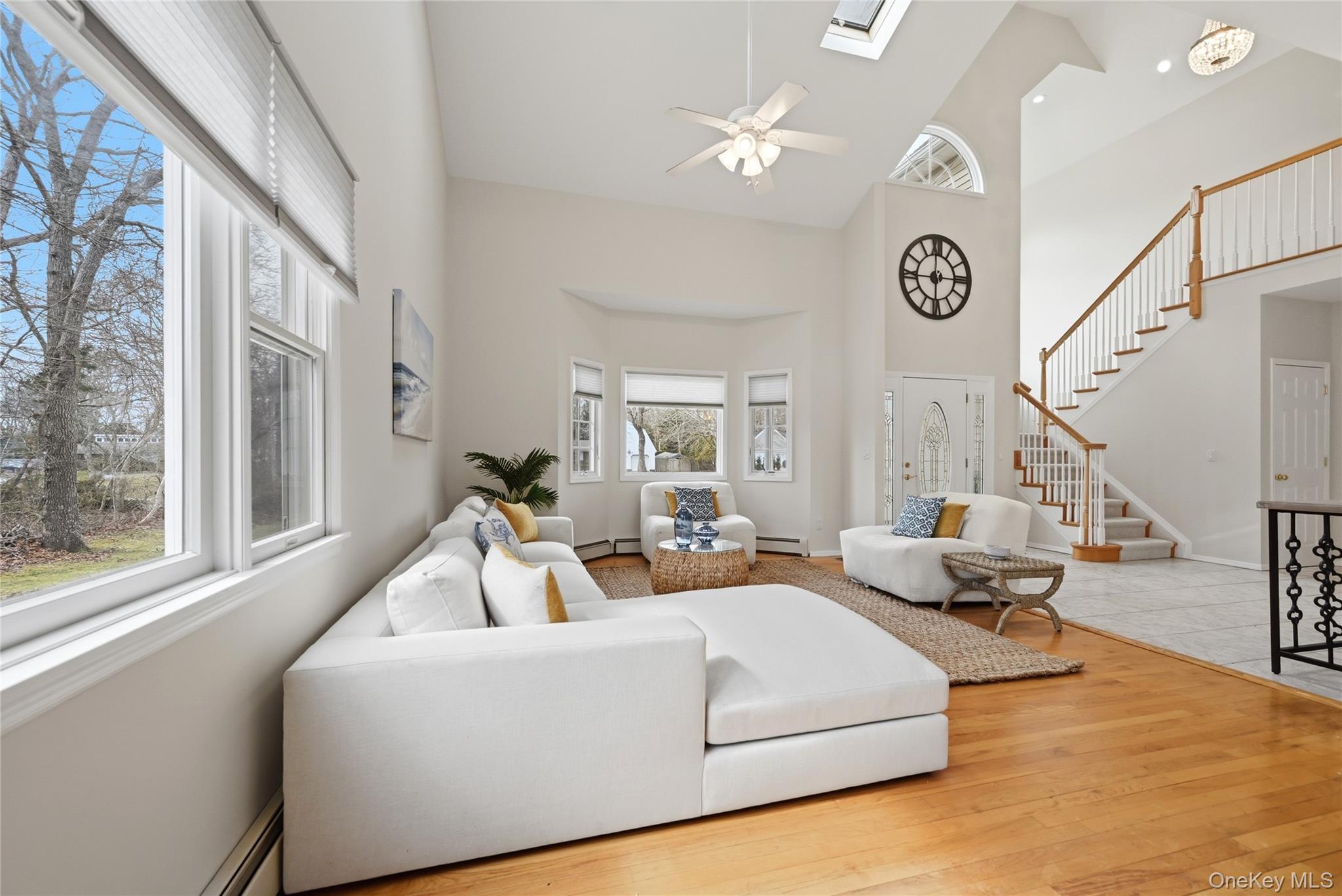 5 Mill Race Road Hampton Bays, NY 11946 - Photo 11 of 34 a living room with couches and a large window with outer view