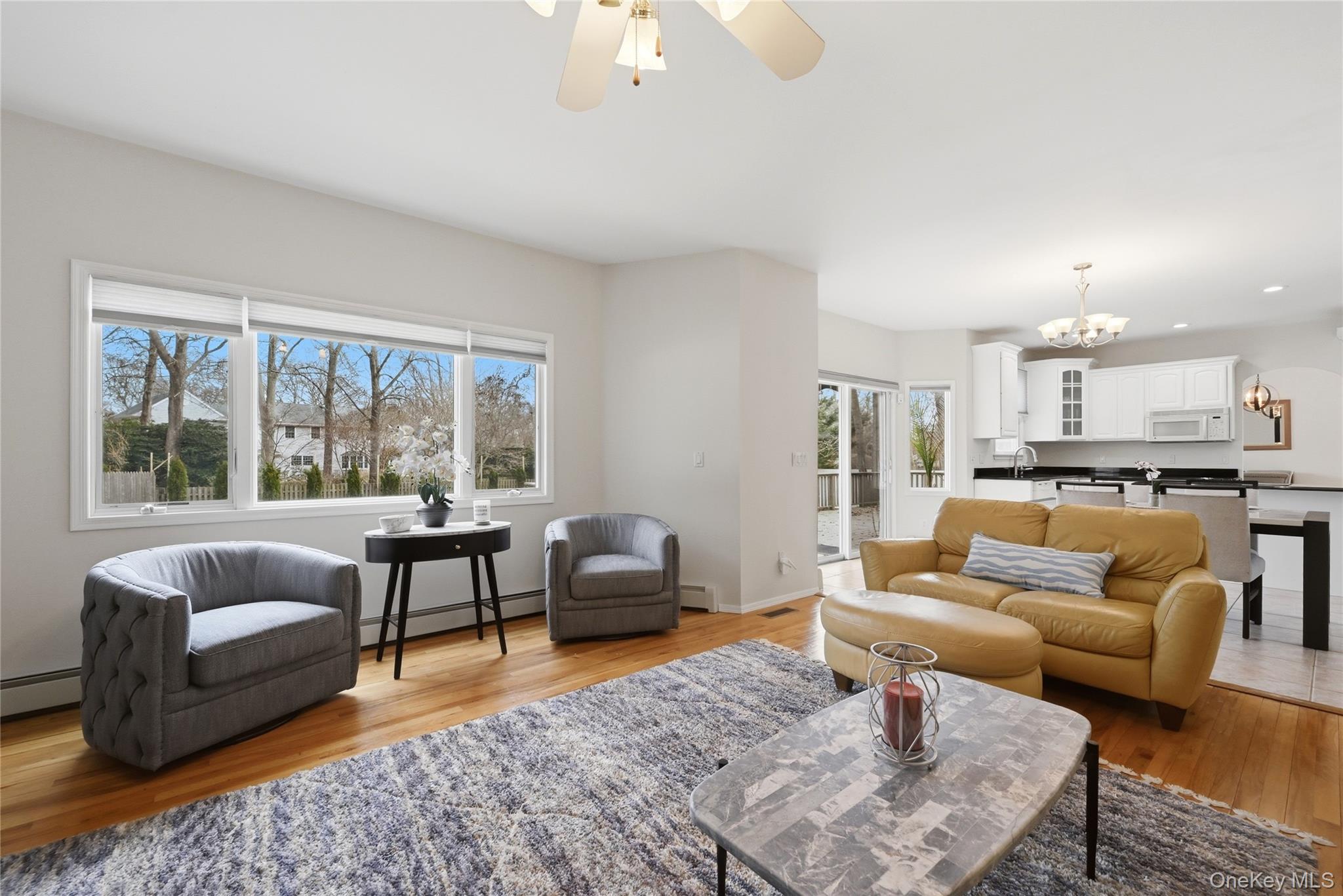 5 Mill Race Road Hampton Bays, NY 11946 - Photo 13 of 34 a living room with furniture and a large window