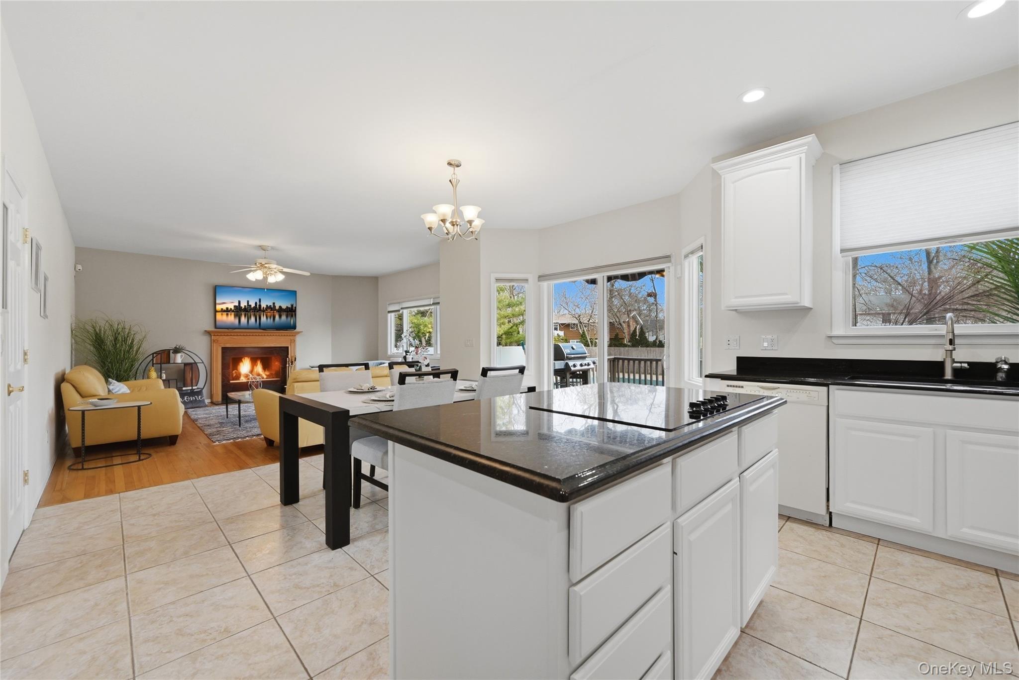 5 Mill Race Road Hampton Bays, NY 11946 - Photo 15 of 34 a kitchen with stainless steel appliances granite countertop a sink and a stove