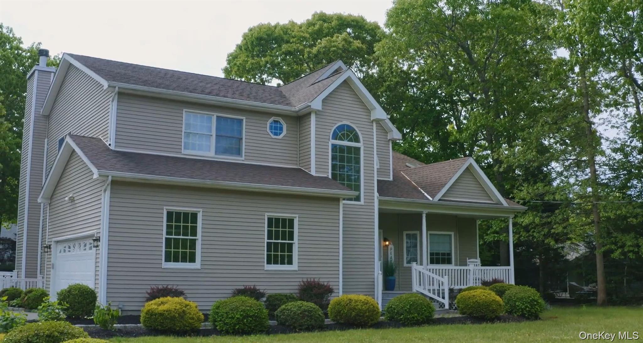 5 Mill Race Road Hampton Bays, NY 11946 - Photo 2 of 34 a front view of a house with garden