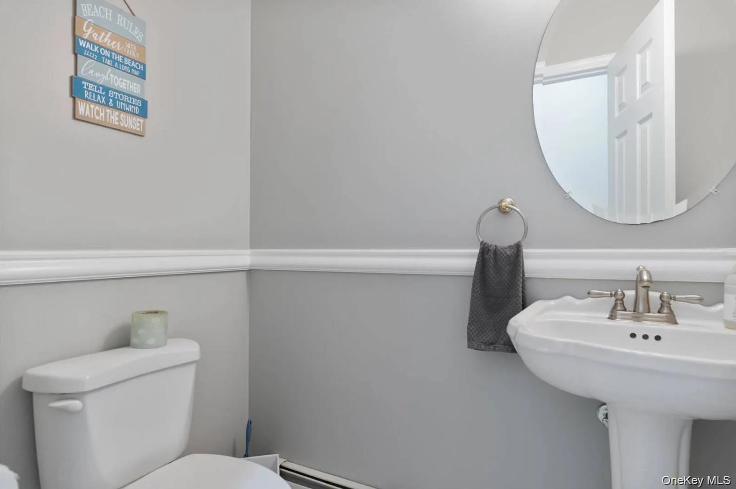 5 Mill Race Road Hampton Bays, NY 11946 - Photo 21 of 34 a bathroom with a sink and a mirror
