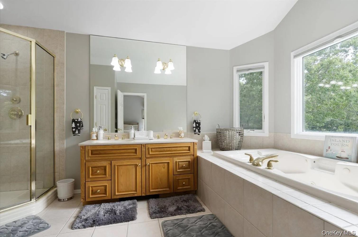 5 Mill Race Road Hampton Bays, NY 11946 - Photo 25 of 34 a large white bathroom with a tub a sink and mirror