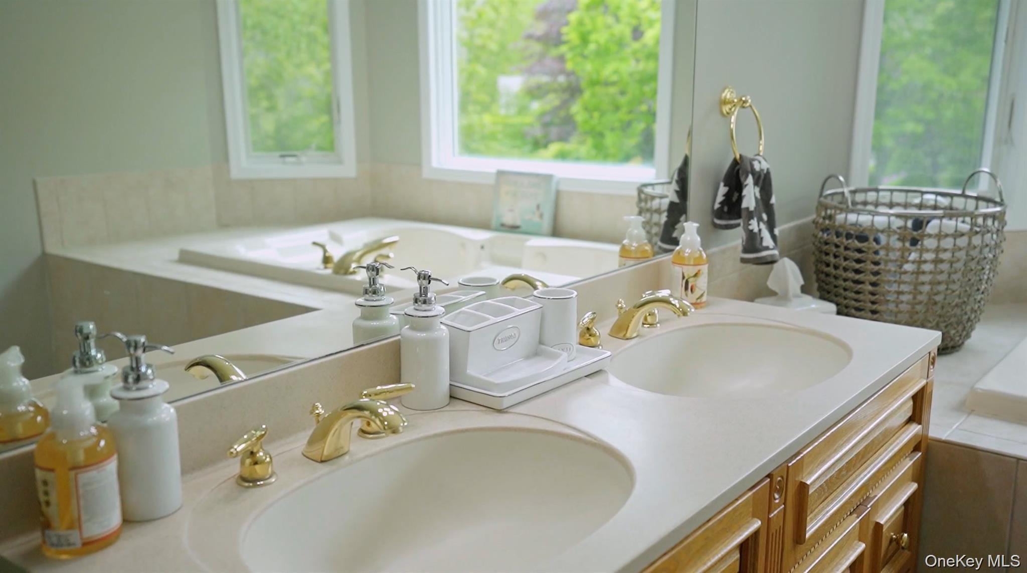 5 Mill Race Road Hampton Bays, NY 11946 - Photo 26 of 34 a bathroom with a granite countertop sink and a large mirror