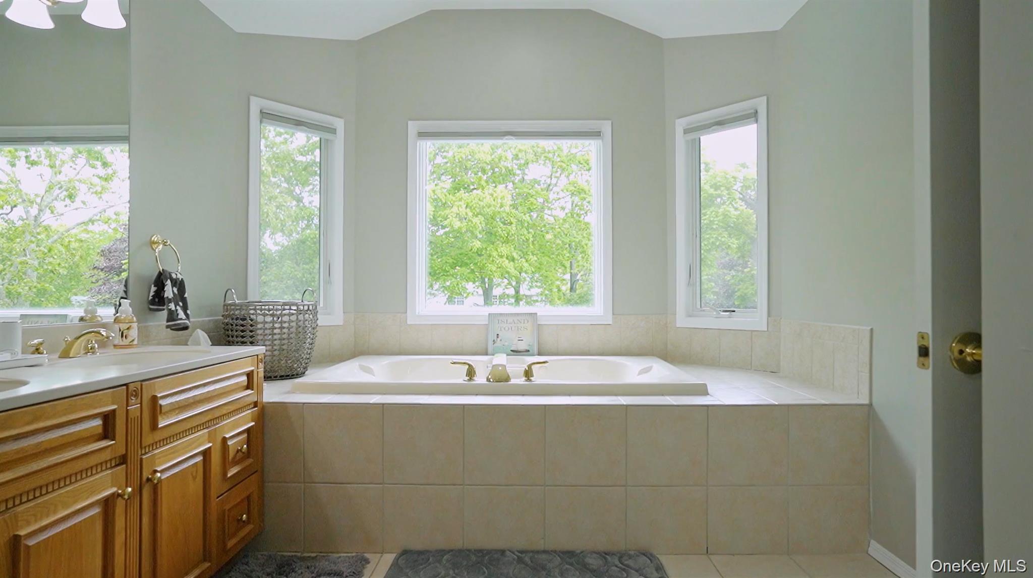 5 Mill Race Road Hampton Bays, NY 11946 - Photo 27 of 34 a bathroom with a sink and a bathtub