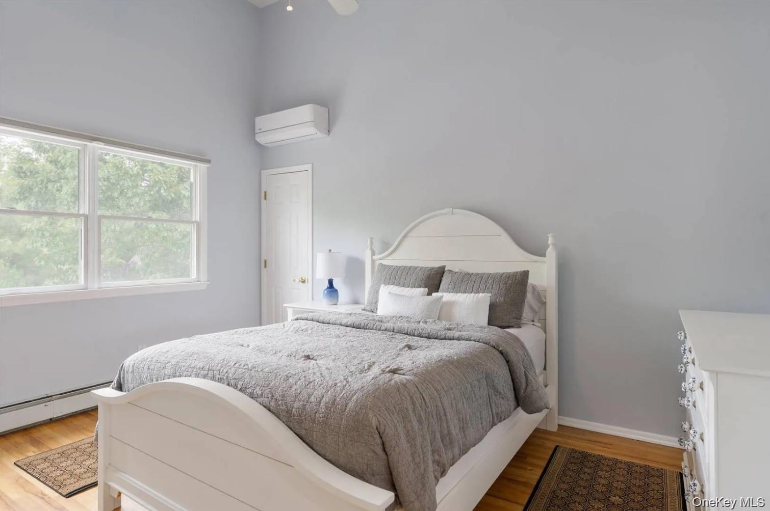 5 Mill Race Road Hampton Bays, NY 11946 - Photo 29 of 34 a bedroom with a bed and a window