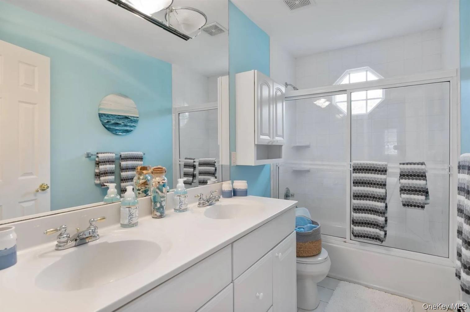5 Mill Race Road Hampton Bays, NY 11946 - Photo 32 of 34 a bathroom with a sink a toilet and shower