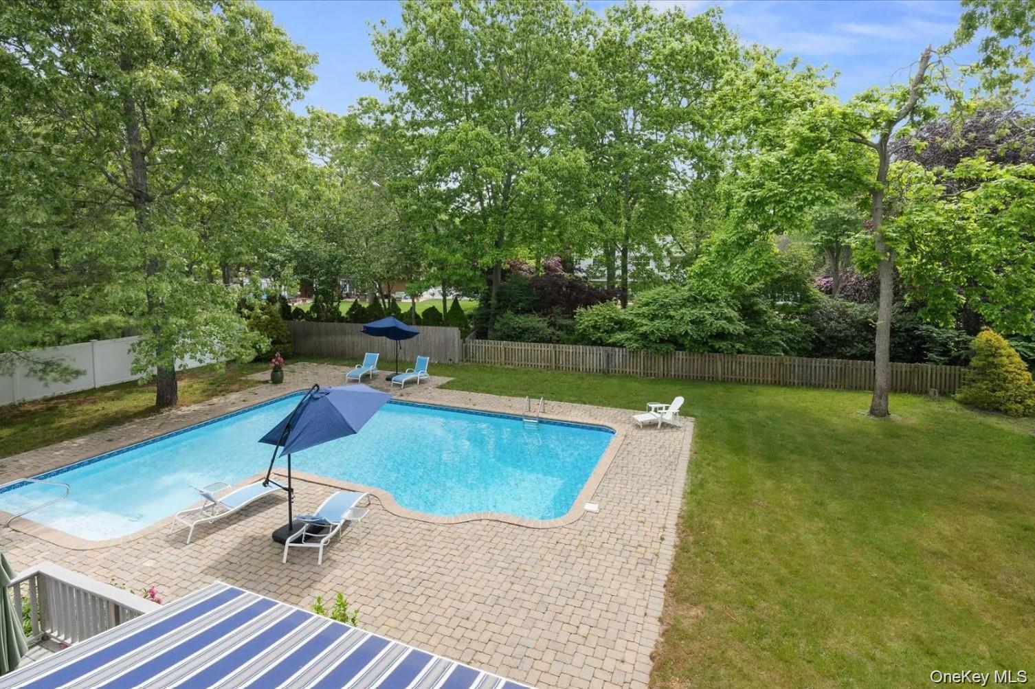 5 Mill Race Road Hampton Bays, NY 11946 - Photo 5 of 34 a view of a swimming pool with a patio and a yard