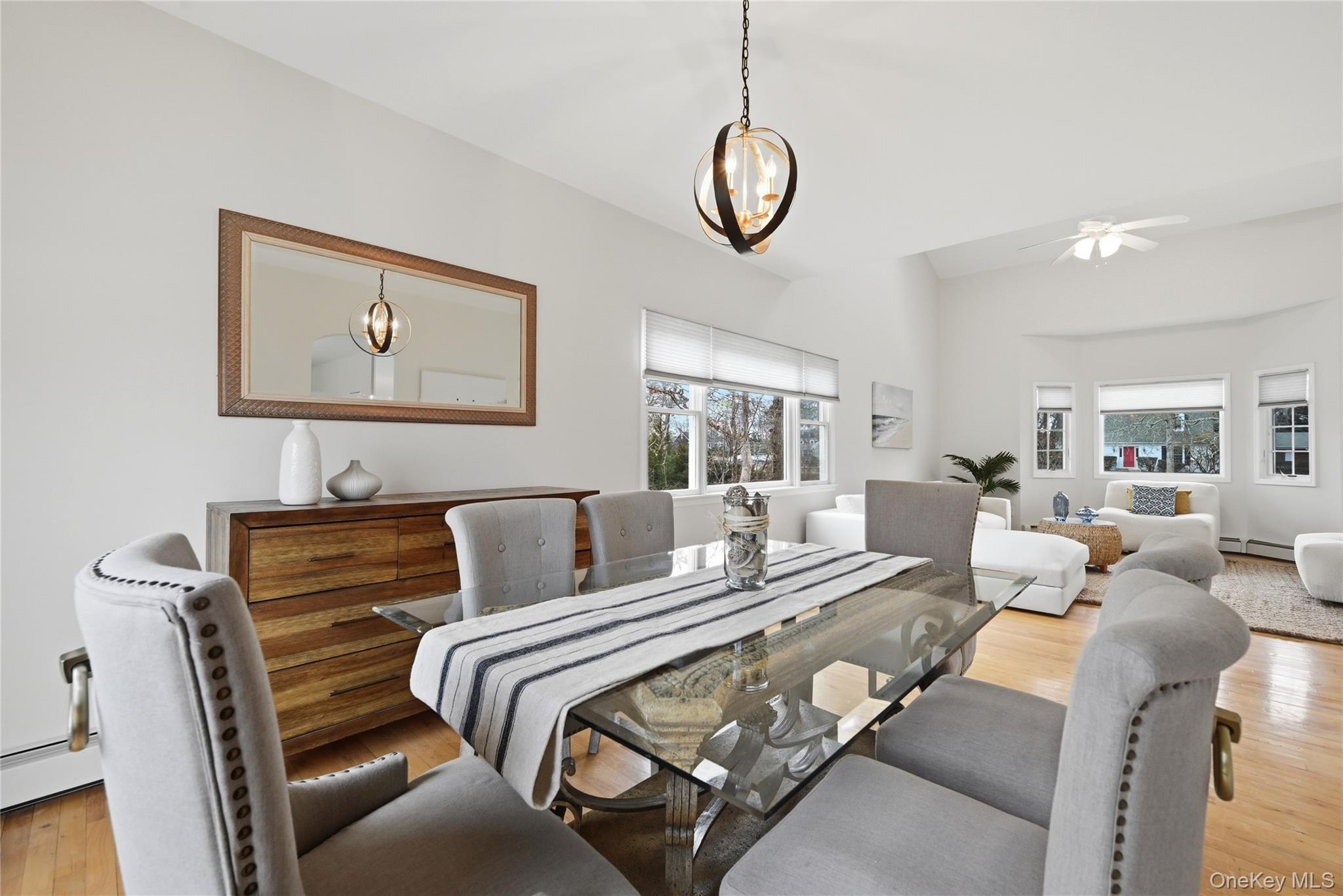 5 Mill Race Road Hampton Bays, NY 11946 - Photo 9 of 34 a bedroom with a large bed and a chandelier