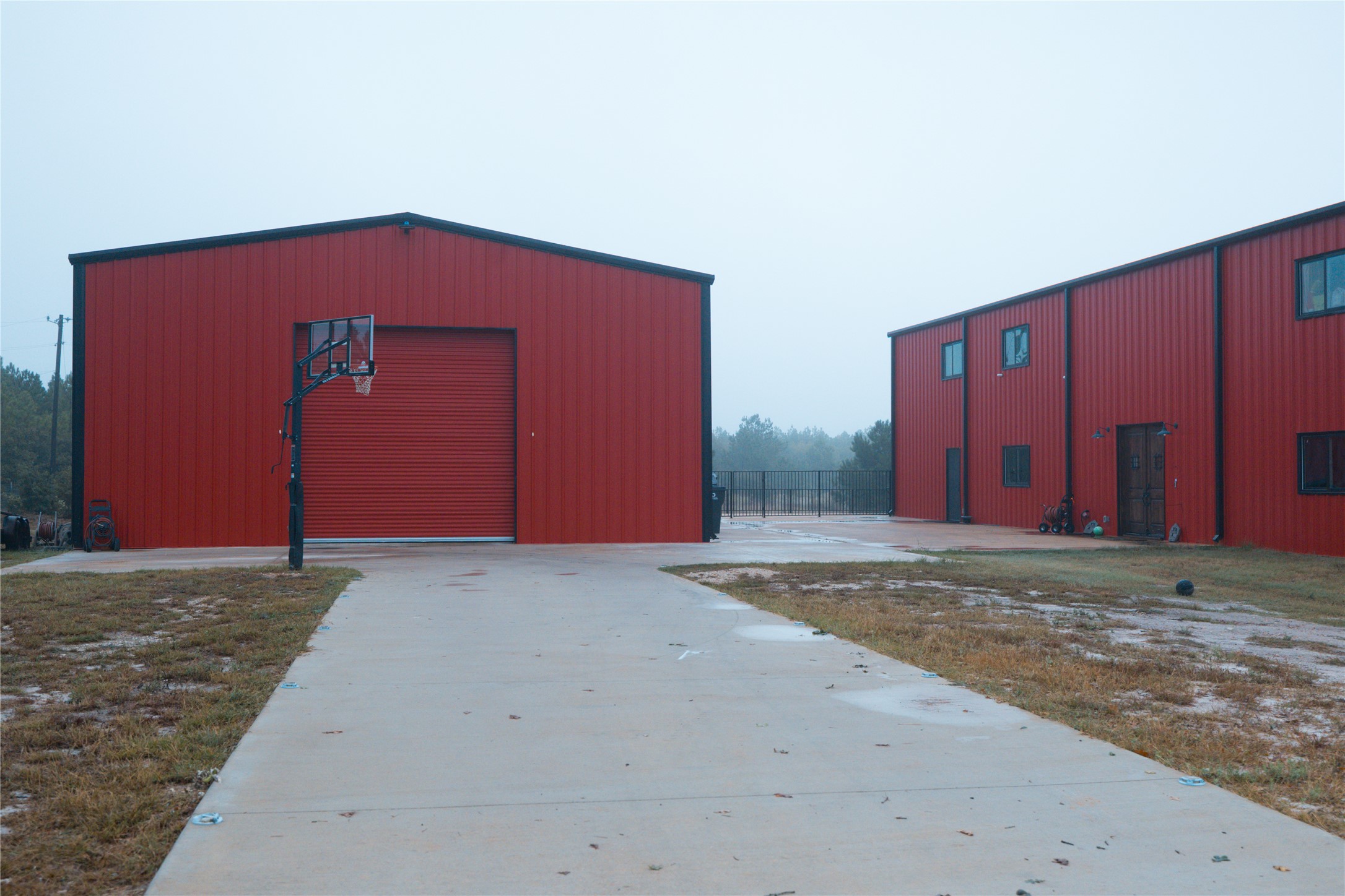 143 County Road Paige, TX 78659 - Photo 36 of 36 View of Garage/Shop with driveway and basketball goal