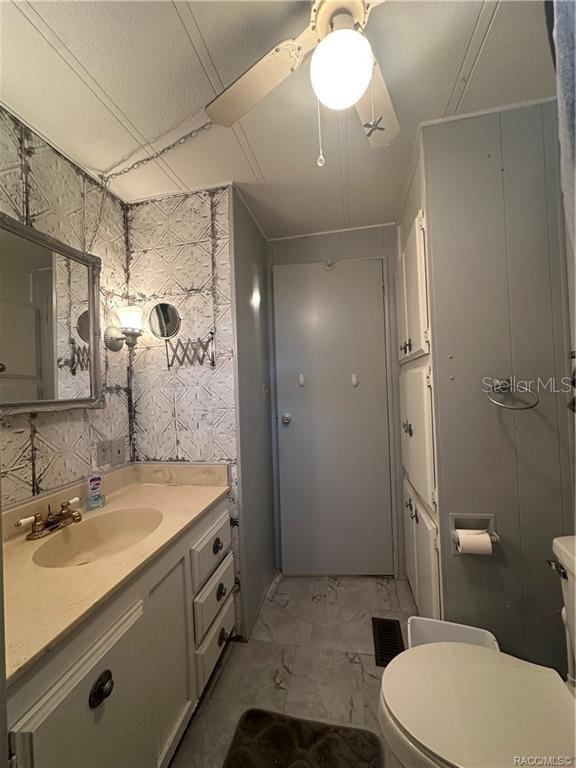 4010 East Dandy Loop Hernando, FL 34442 - Photo 12 of 30 a bathroom with a sink a toilet a mirror and shower