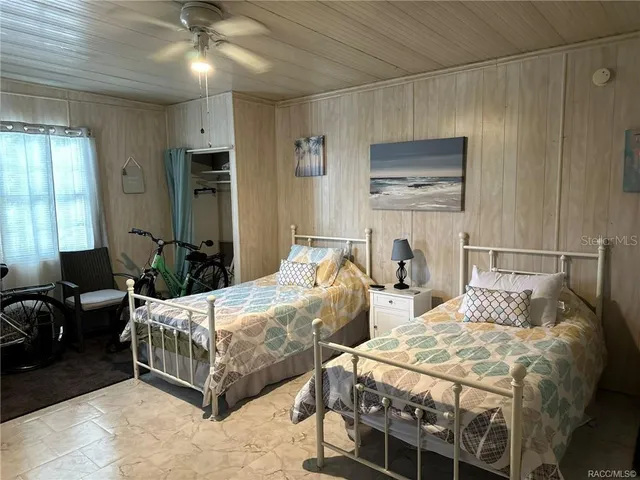 a bedroom with two beds and painting on the wall