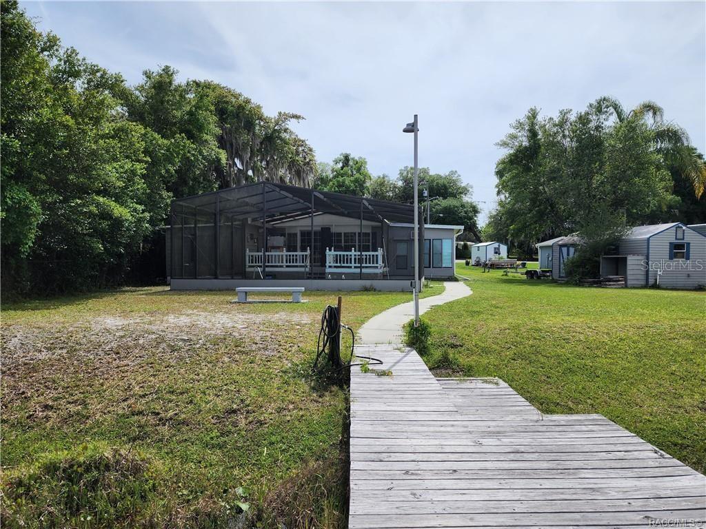 4010 East Dandy Loop Hernando, FL 34442 - Photo 3 of 30 a swimming pool with outdoor seating and yard