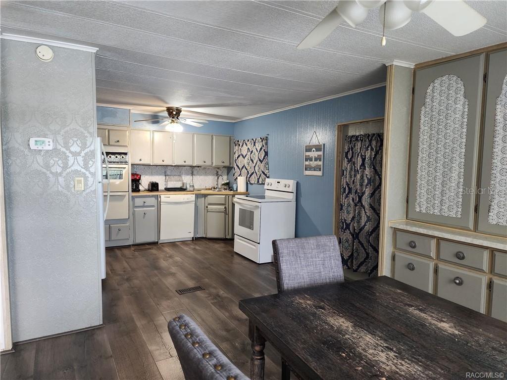 4010 East Dandy Loop Hernando, FL 34442 - Photo 4 of 30 a kitchen with a sink stainless steel appliances and white cabinets