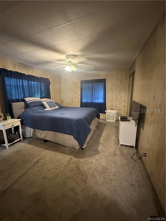 4010 East Dandy Loop Hernando, FL 34442 - Photo 7 of 30 a bed room with a bed and a chair