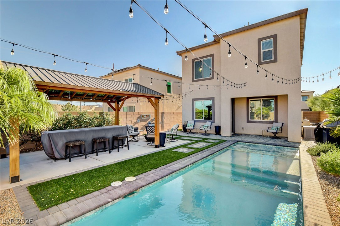 9688 Rankin Rdg Court Las Vegas, NV 89178 - Photo 50 of 53 An inviting backyard oasis offers a sparkling pool and a covered outdoor entertaining area.