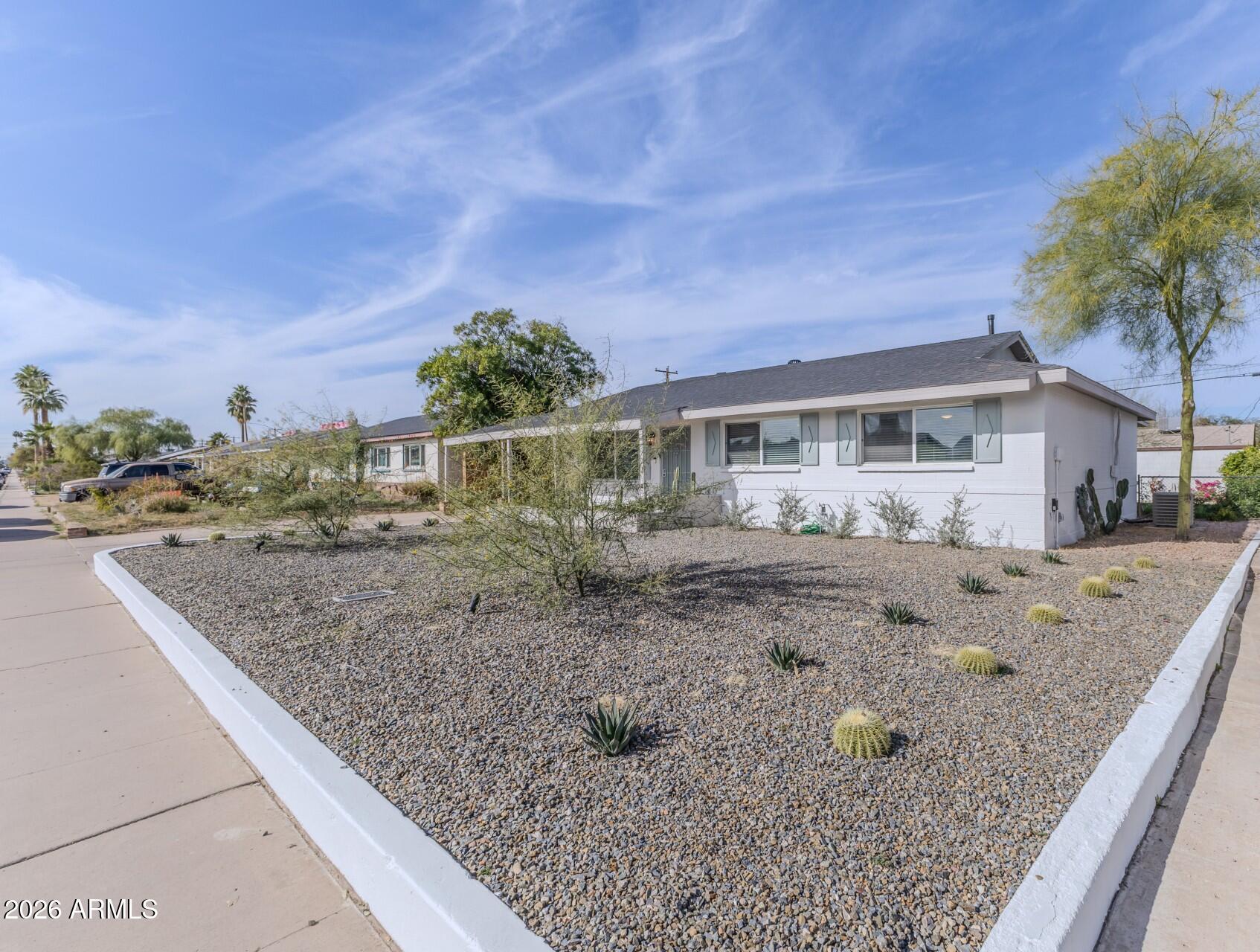 a view of a house with a backyard