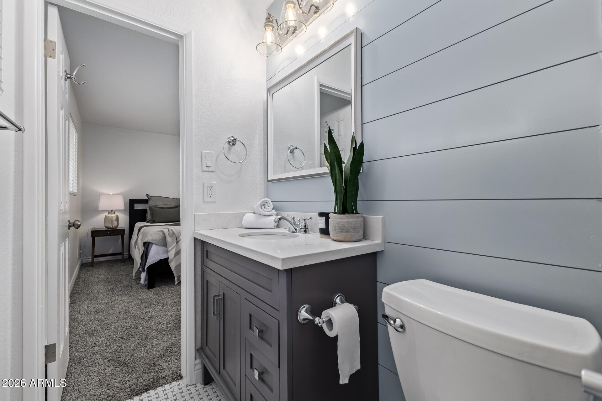 424 East Fillmore Street Tempe, AZ 85288 - Photo 11 of 20 a bathroom with a toilet sink and mirror