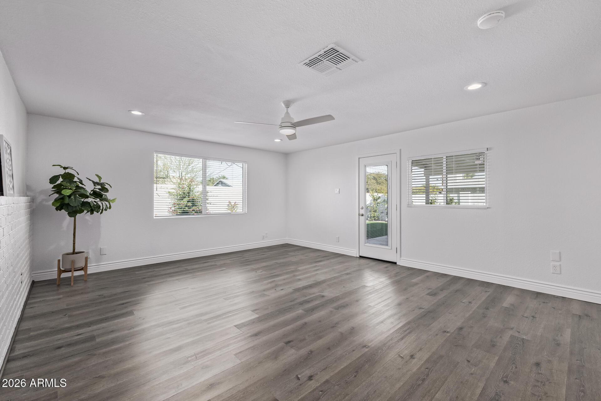 424 East Fillmore Street Tempe, AZ 85288 - Photo 18 of 20 a view of an empty room with wooden floor and a window