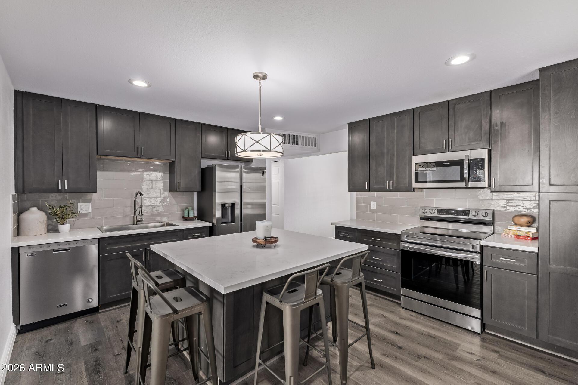 424 East Fillmore Street Tempe, AZ 85288 - Photo 7 of 20 a kitchen with a stove a sink and a refrigerator
