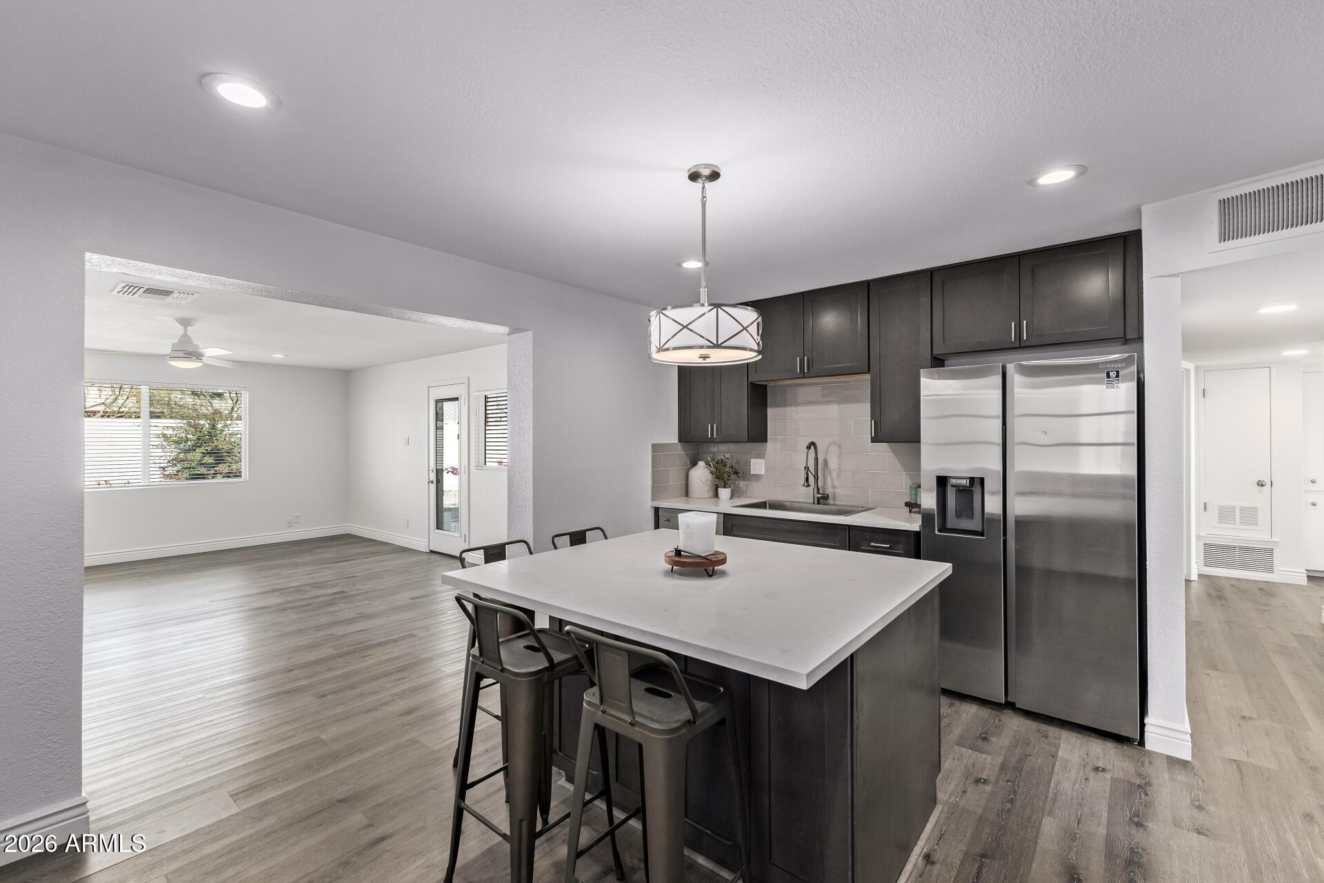 424 East Fillmore Street Tempe, AZ 85288 - Photo 8 of 20 a kitchen with a table chairs refrigerator and microwave