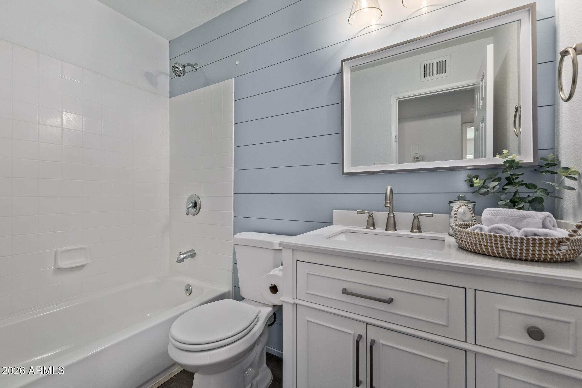 424 East Fillmore Street Tempe, AZ 85288 - Photo 10 of 20 a bathroom with a granite countertop toilet sink and a mirror