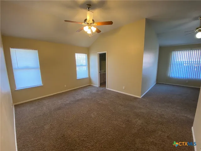 a bathroom with a granite countertop toilet and a shower