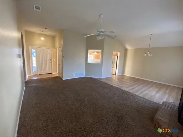a living room with a fireplace and a window