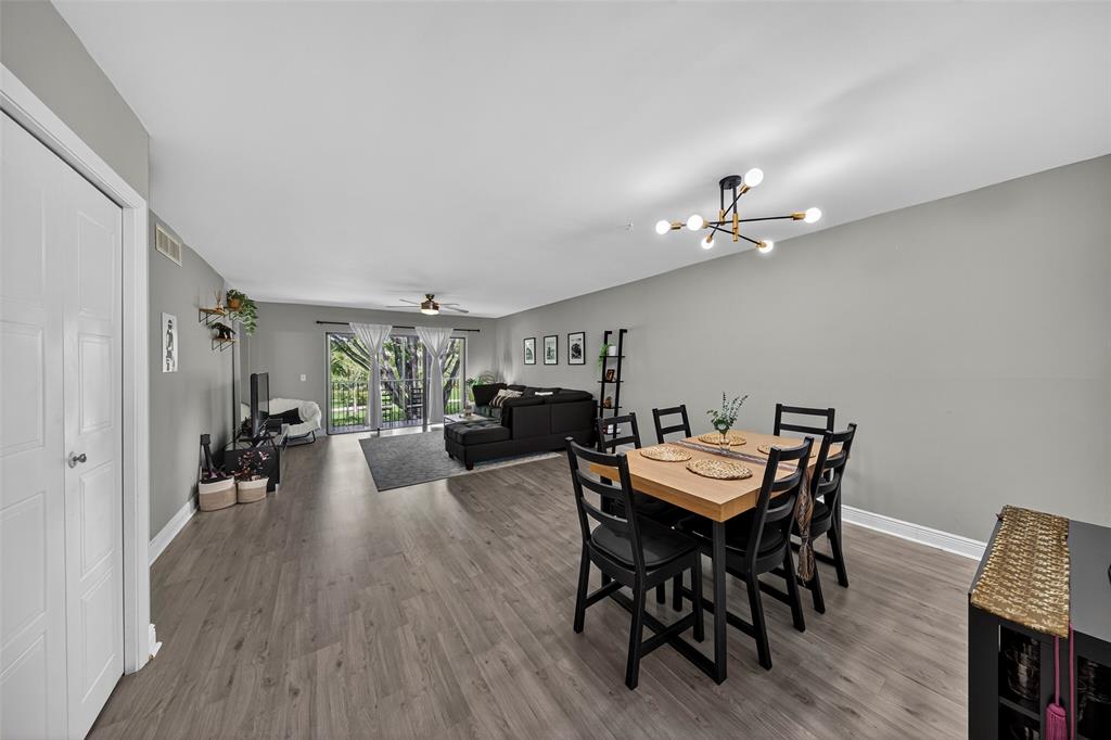 412 Lakeview Drive, Unit 202 Weston, FL 33326 - Photo 17 of 34 a view of a dining room with furniture and wooden floor