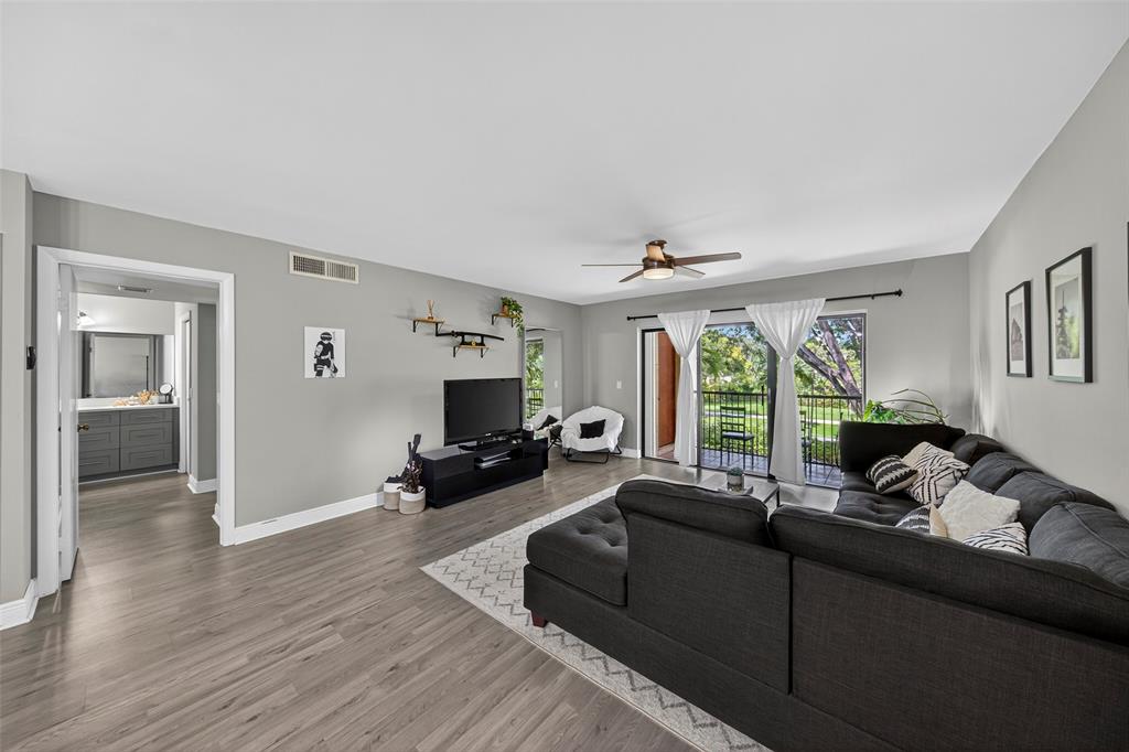 412 Lakeview Drive, Unit 202 Weston, FL 33326 - Photo 20 of 34 a living room with furniture flat screen tv and a large window