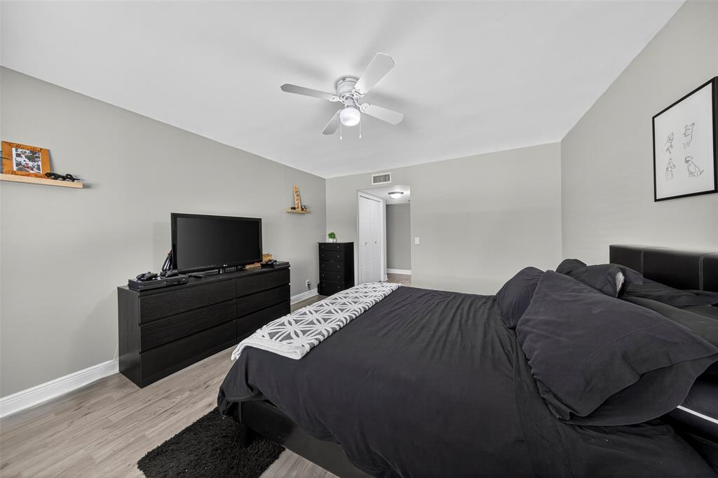 412 Lakeview Drive, Unit 202 Weston, FL 33326 - Photo 23 of 34 a bedroom with a bed and a flat screen tv