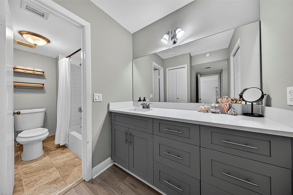 412 Lakeview Drive, Unit 202 Weston, FL 33326 - Photo 24 of 34 a bathroom with a toilet a double vanity sink and a mirror