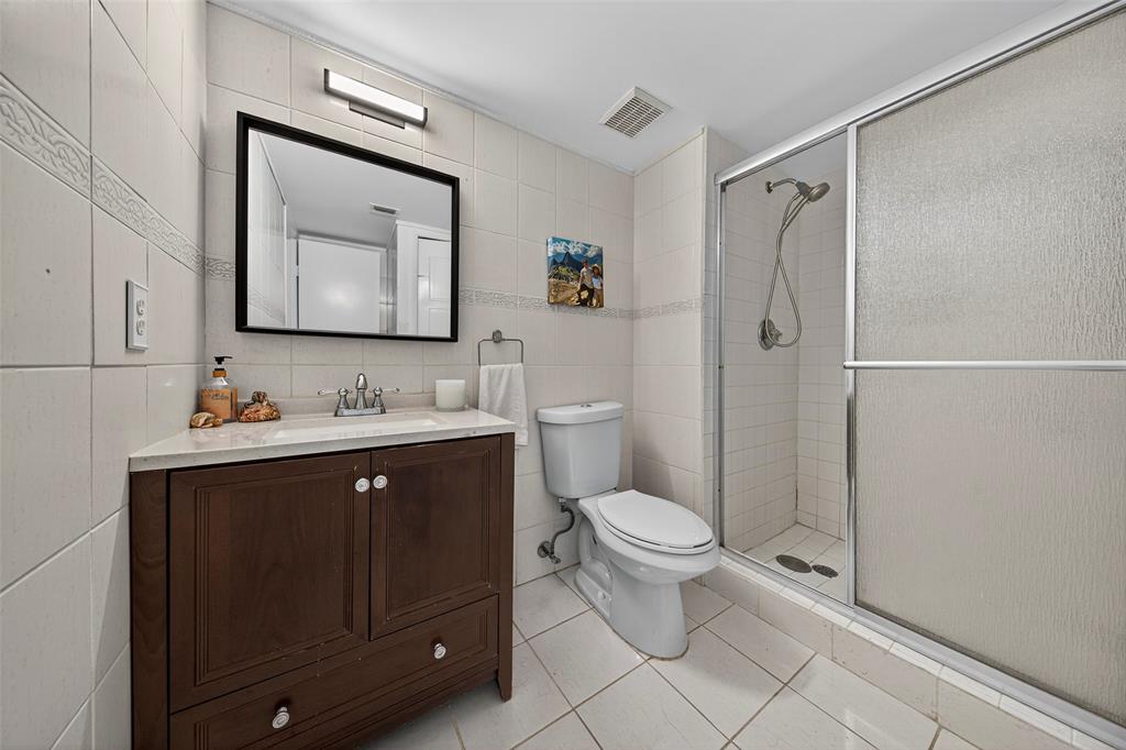 412 Lakeview Drive, Unit 202 Weston, FL 33326 - Photo 29 of 34 a bathroom with a toilet sink double vanity and mirror