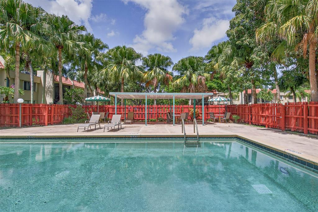 412 Lakeview Drive, Unit 202 Weston, FL 33326 - Photo 30 of 34 a view of a garden with a bench