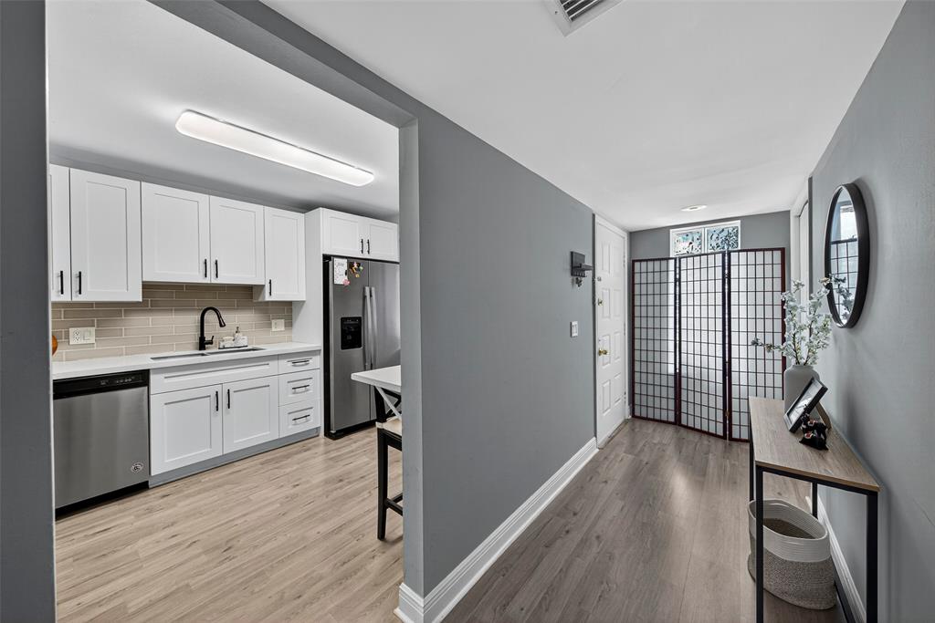412 Lakeview Drive, Unit 202 Weston, FL 33326 - Photo 5 of 34 a kitchen with granite countertop a refrigerator cabinets and wooden floor
