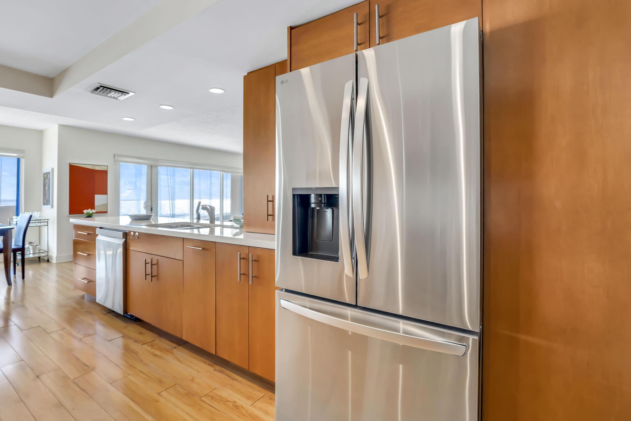 4301 North Ocean Boulevard, Unit 1002 Boca Raton, FL 33431 - Photo 12 of 71 a kitchen with stainless steel appliances granite countertop a refrigerator and a stove top oven