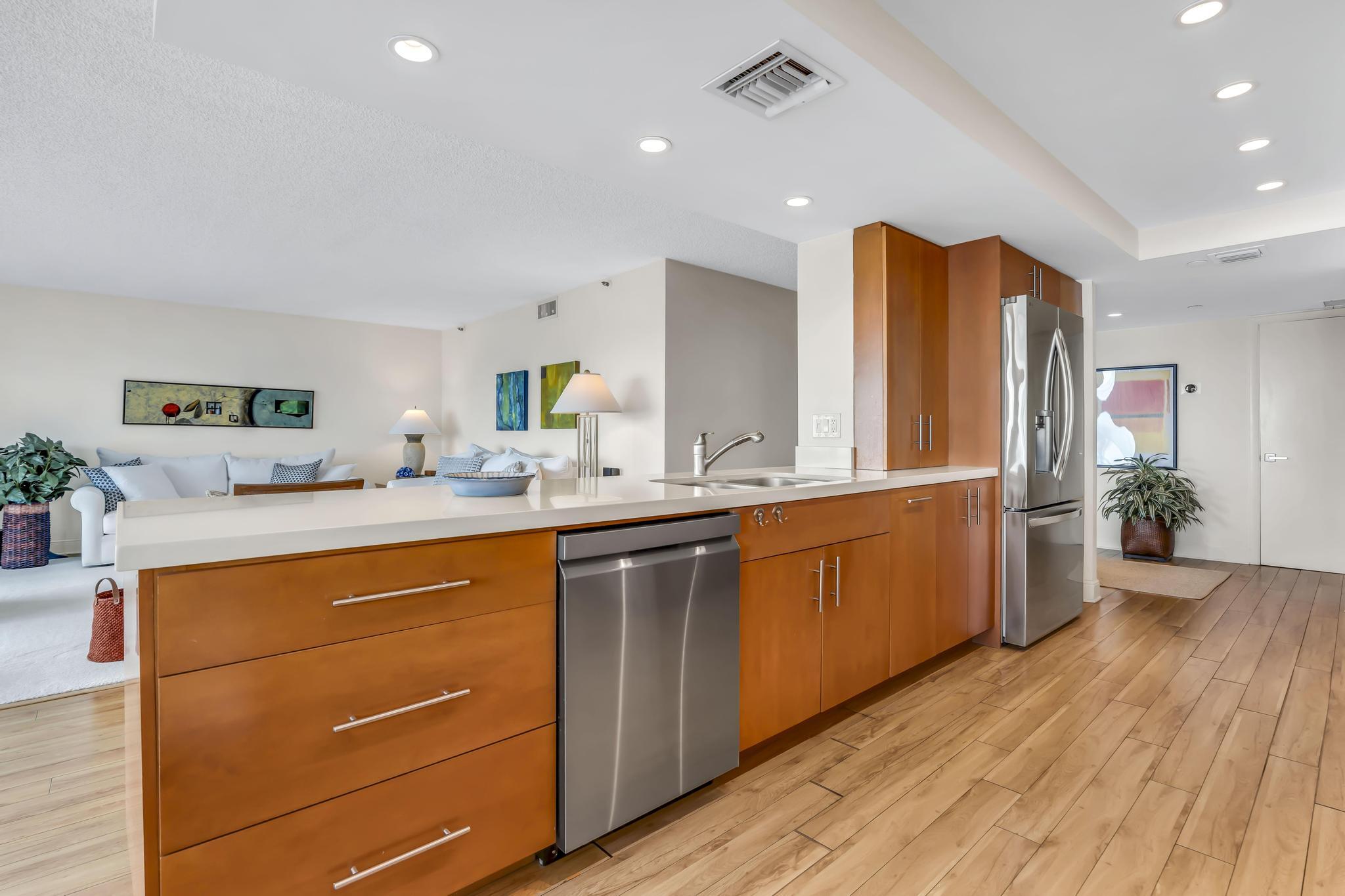 4301 North Ocean Boulevard, Unit 1002 Boca Raton, FL 33431 - Photo 16 of 71 a kitchen with stainless steel appliances granite countertop a sink stove and refrigerator