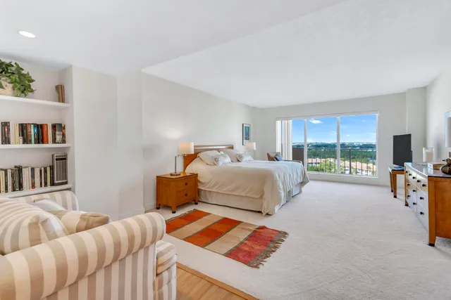 a bathroom with a granite countertop sink mirror vanity and toilet