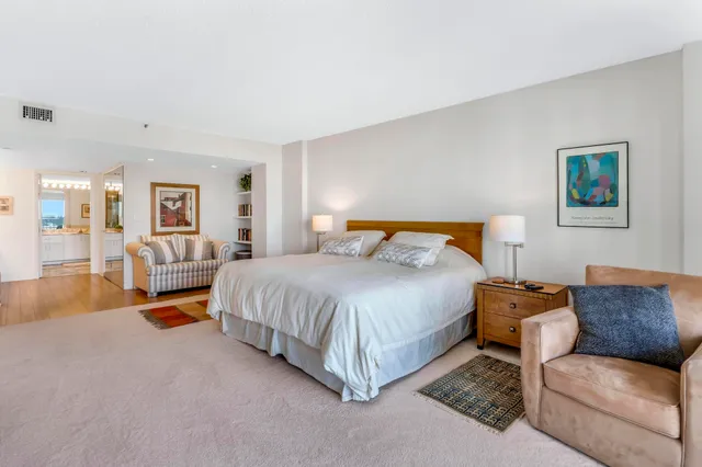 a bathroom with a sink mirror and a shower