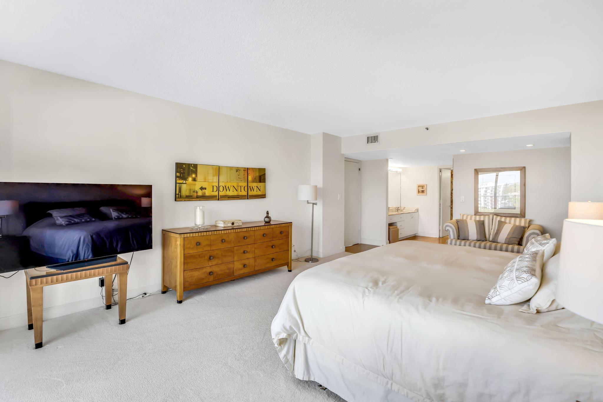 4301 North Ocean Boulevard, Unit 1002 Boca Raton, FL 33431 - Photo 20 of 71 a bedroom with a bed and chair