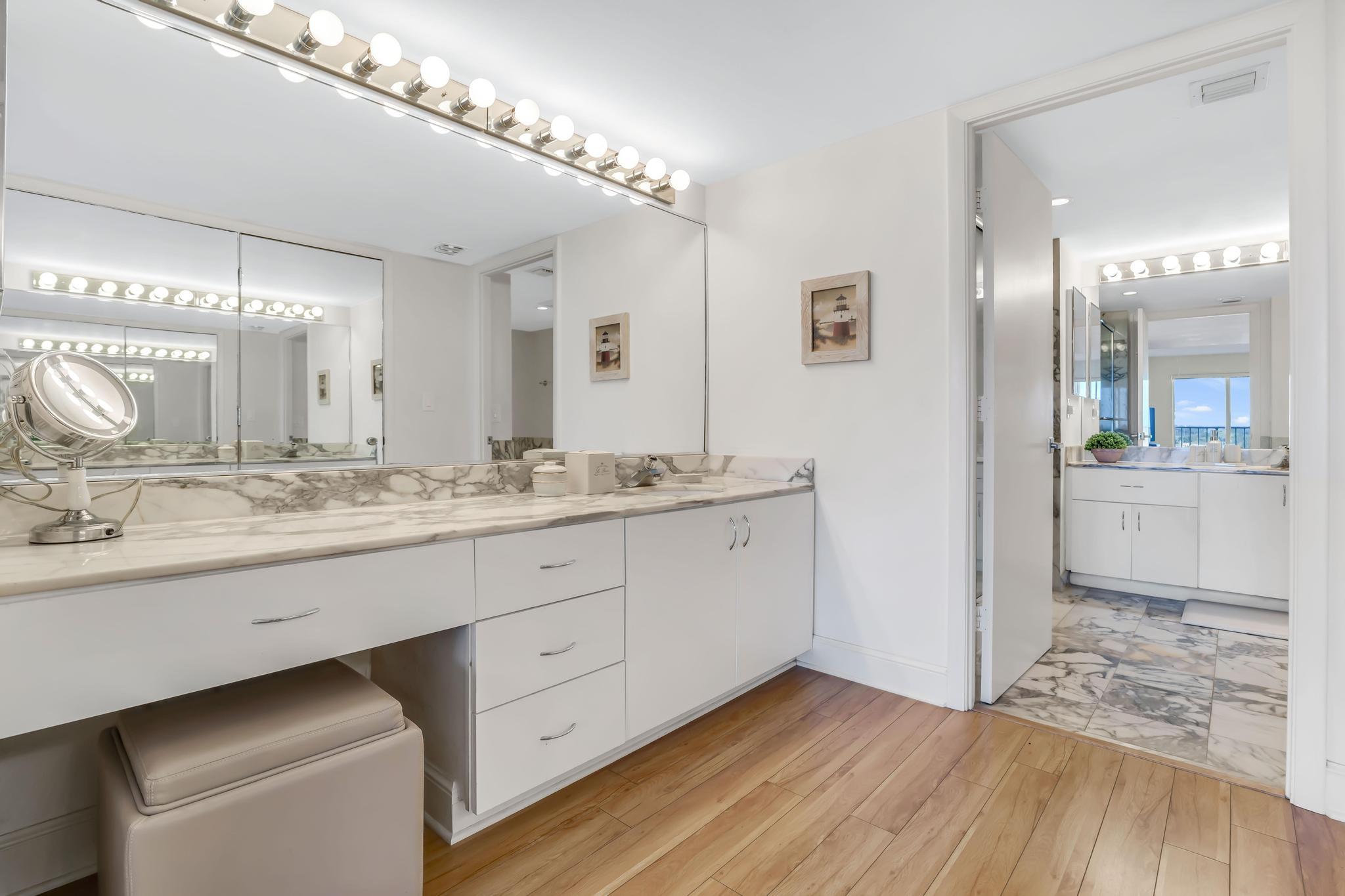 4301 North Ocean Boulevard, Unit 1002 Boca Raton, FL 33431 - Photo 21 of 71 a bathroom with a sink double vanity and a mirror