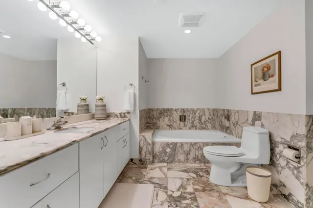 a bedroom with two beds and large window